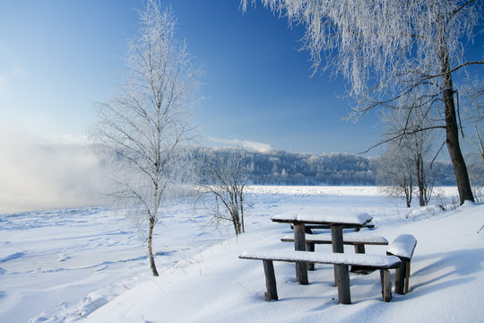 Little table and bench on coast of the river