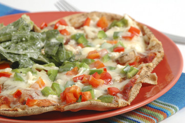 Homemade vegetarian pizza with a side salad.