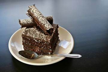 A slice of chocolate cake on a white plate.