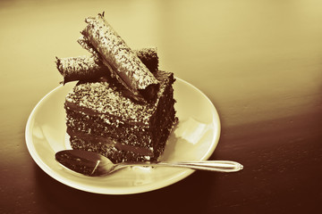 A slice of chocolate cake on a white plate.