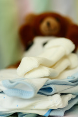A shot of baby clothing and doll in a nursery