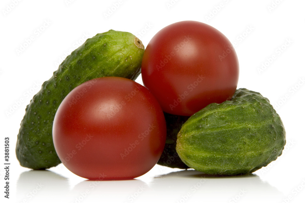 Wall mural tomatoes and gherkins over white background