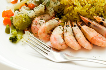 some shrimps and rice on the white table. Closeup