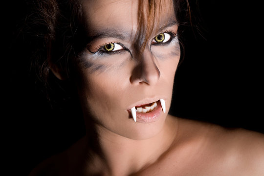Dangerous looking female vampire on black background
