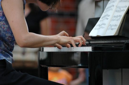 Young woman playing piano during live jazz performance
