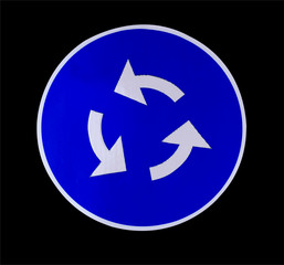 blue and white roundabout traffic sign