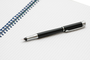 Black ink pen on the spiral book