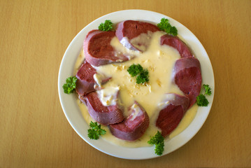 Corned beef tongue with horseradish sauce on the plate