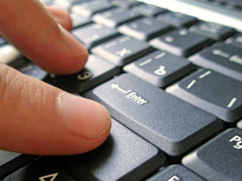 keyboard of laptop with hand