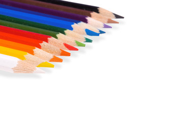 Color pencils lay on a white background