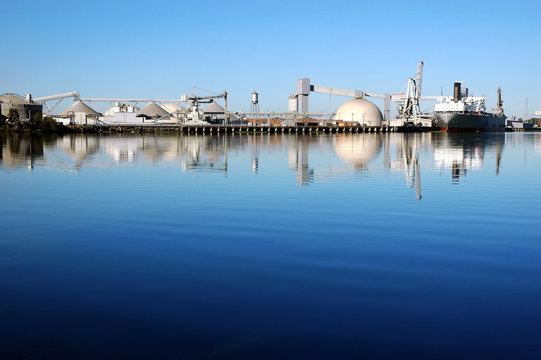 Cargo Ship Reflected near Seaport Loading Docks