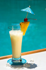Pina Colada cocktail on swimming pool side
