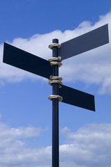 Blank signpost against a blue sky. With clipping path 