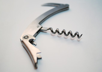 silver bottle opener with blue lights white background