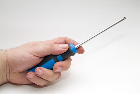 hand and screwdriver over white background