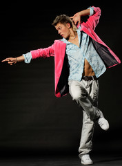 Nightclub dancer posing on a dark background