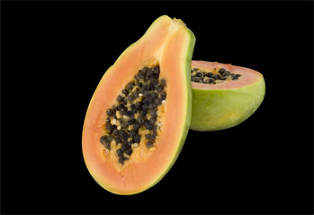 Papaya fruti cut in halves on white background