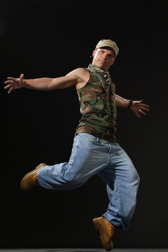 krump style dancer jumping on leg