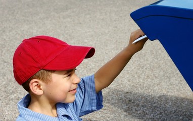 Boy posting a letter