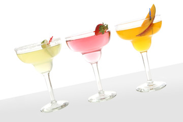 Three colorful cocktails over a white background