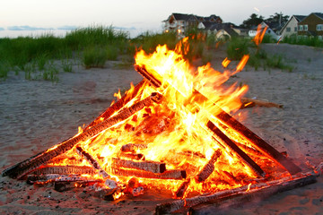 A beautiful campfire is on the beach. - 3922521