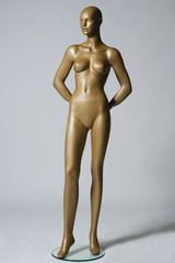 the mannequin standing alone on grey background