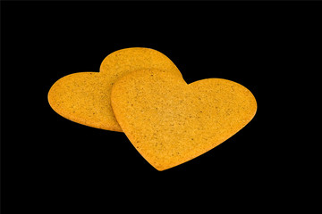 heart shaped gingerbread biscuit on black background