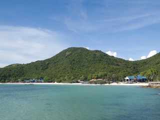 Fototapeta na wymiar Beach on a tropical island with dense forest behind