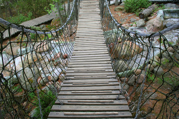 Fototapeta premium Suspension bridge over small river