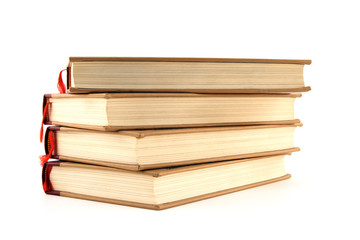Four stacked hardcover books isolated on white background.