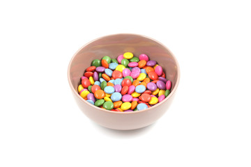 bowl of colorful candies isolated on white