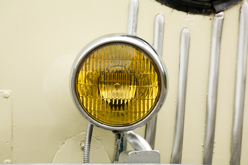 yellow car headlight close up shot