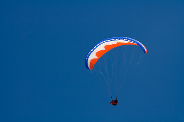 Paraglider on blue sky