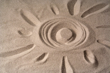 Fototapeta na wymiar draw of a sun on sand