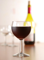 Glass of wine with bottle