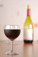 Glass of wine with bottle