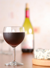 Glass of wine with bottle