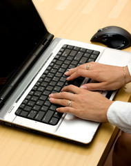 Woman working on laptop.