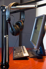 Headphones with monitor and keyboard in background