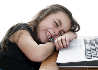  Young girl lying down and working on the laptop