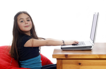  Young girl lying down and working on the laptop