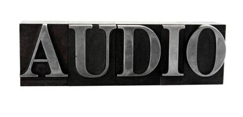 the word 'AUDIO' in old, inkstained metal type