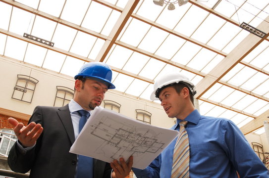 Two architects reviewing the blueprints