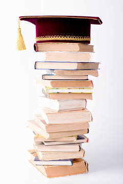 maste's cap with a books