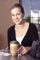 Young woman enhoying her coffee or tea