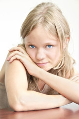 beautiful young girl with her hands on the table