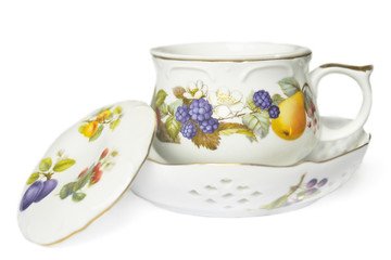 teacup, saucer and cover decorated with fruit and berries