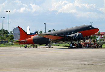 Historic transport airplane parked on airfield
