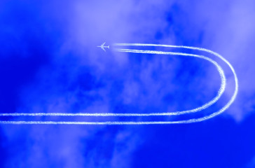  Airplane in the sky with jet trail