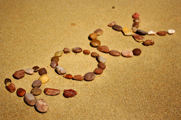 Fototapeta na wymiar Stones in the sand saying rock
